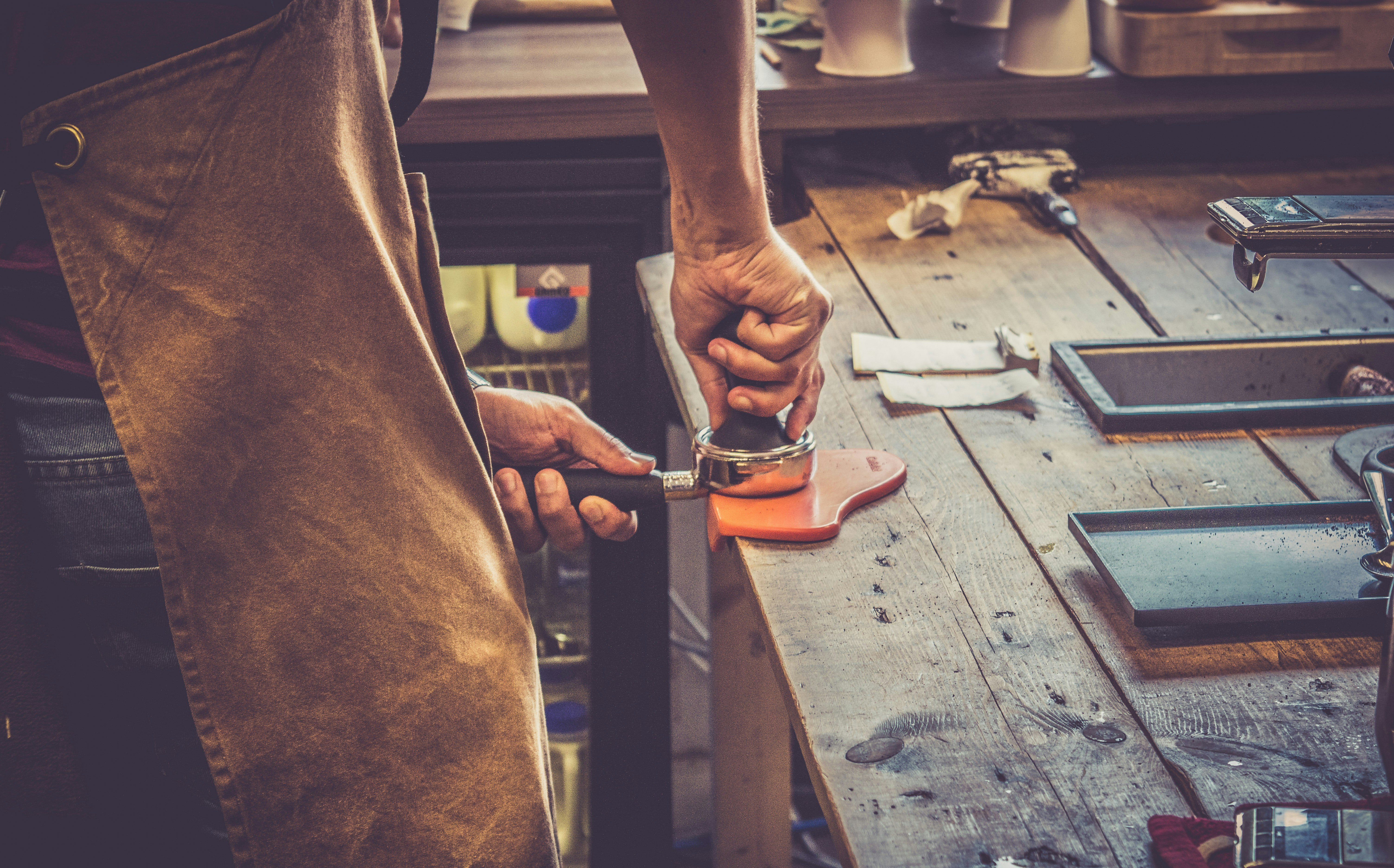 person holding black and silver hand tool